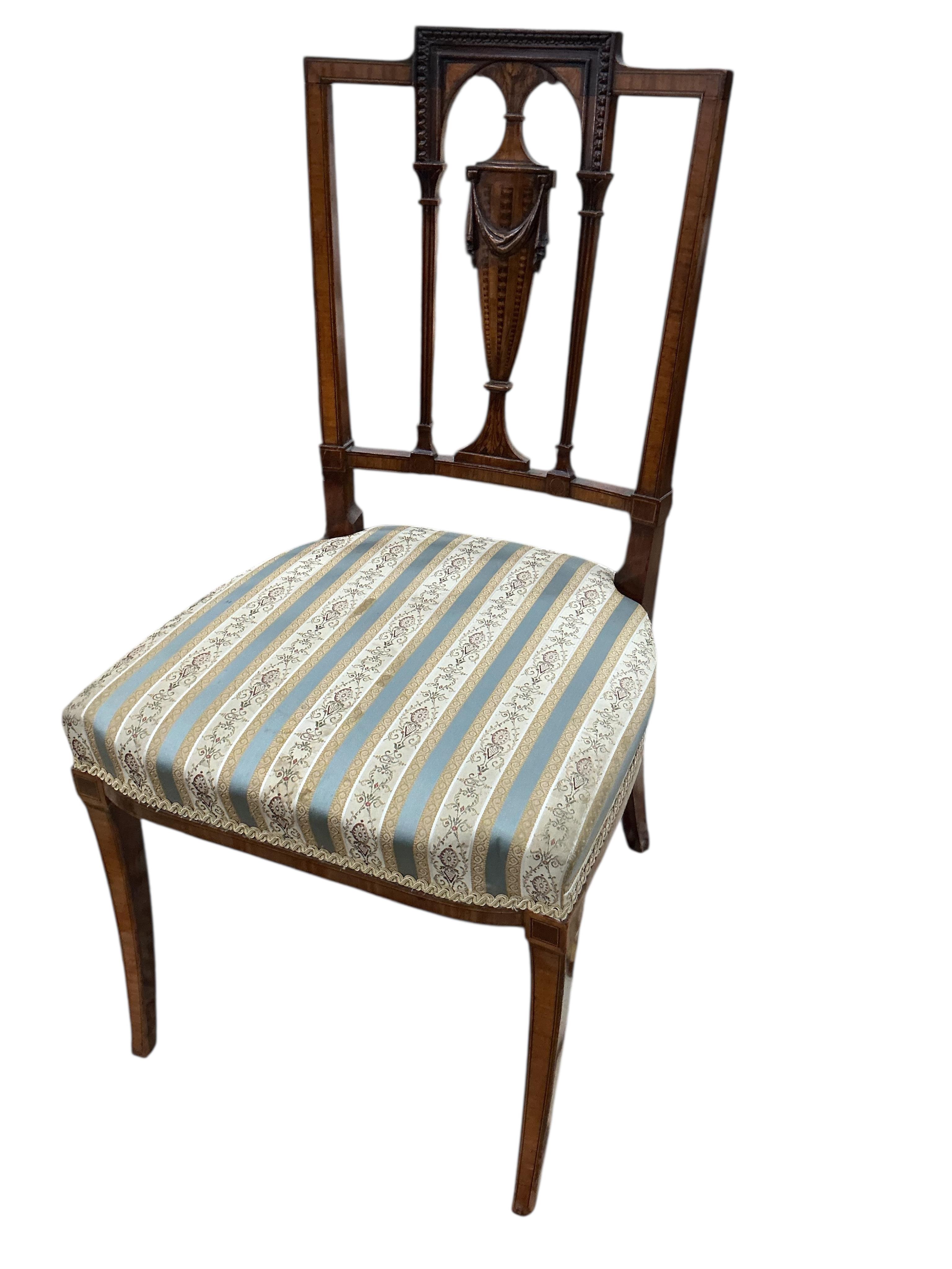 A set of five Edwardian Sheraton revival mahogany and marquetry dining chairs, one with arms, and a Victorian dressing stool
